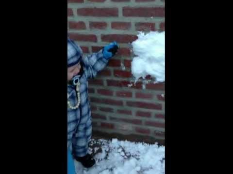 Child laughing at snow in Denmark
