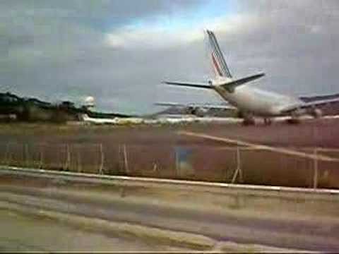 Airbus 340 taking off, blowing people off beach